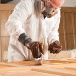 Person laminating the wooden door